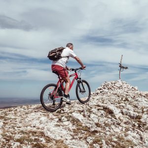 man riding bicycle on off road